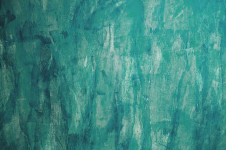 Aquamarine grungy painted stucco wall backgroundの写真素材