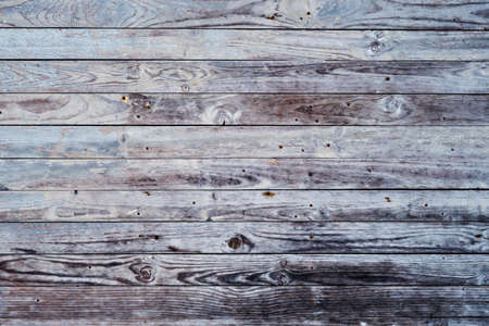 Old distressed wooden planks wall with pale blue peeling paint, grunge wood background or textureの写真素材