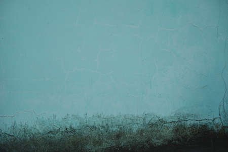 Aquamarine color old plastered wall with damp, grunge background with textureの写真素材