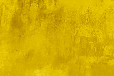 Yellow painted canvas backdrop, grungy background or textureの写真素材
