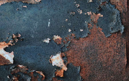 Old rusty metal sheet with peeling dark blue paint, grunge background or texureの写真素材