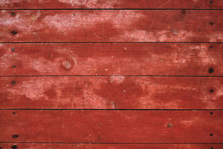 Worn out red painted wooden planks wall, rustic distressed background or textureの写真素材