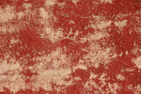 Old distressed wall with worn out red paint, grunge background or textureの写真素材
