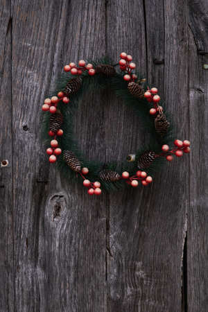 Homemade traditional christmas wreath on rustic wooden doorの写真素材