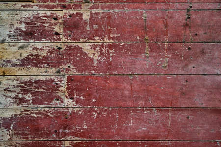 Worn out red painted wooden planks wall, rustic distressed background or textureの写真素材