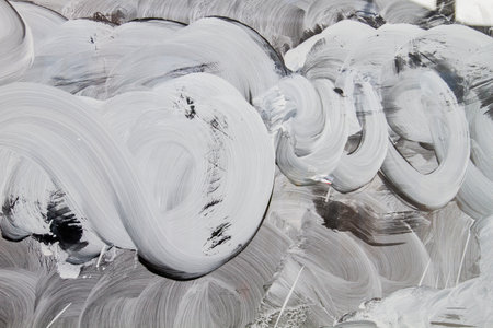 White paint strokes on a shop window, abstract background or textureの写真素材