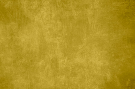 Golden colored venetian stucco wall grunge backgroundの写真素材