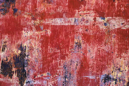 Worn out red painted corroded metal grunge textureの写真素材