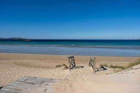 Wooden walkway on the dunes of A Lanzada Beach in Galicia, Spainの写真素材