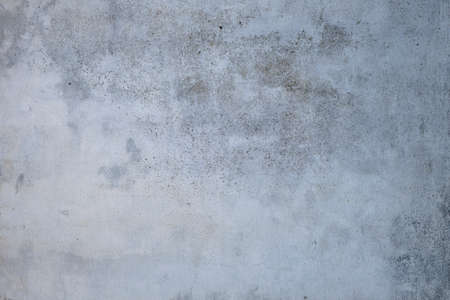 Old weathered white plastered wall texture with damp, grunuge backgroundの写真素材