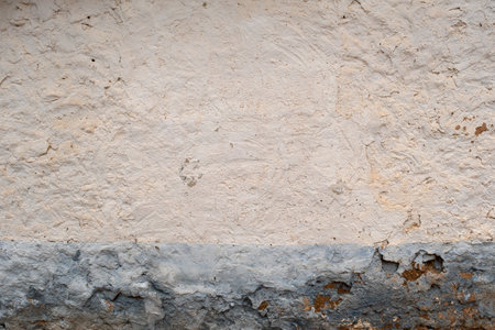 Old distressed lime wash plastered wall with blue skirting board, traditional mediterranean architecture backgroundの写真素材