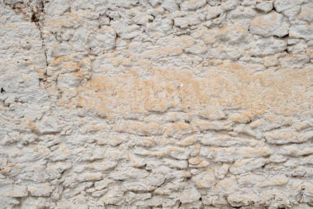 Old traditional limewashed stone wall, white rustic background or textureの写真素材