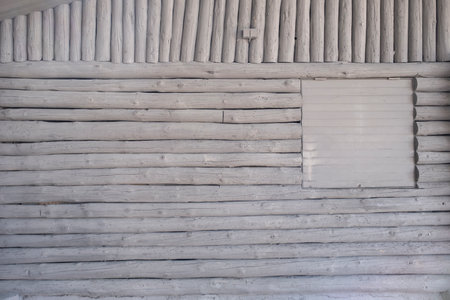 White painted wooden logs wall cladding backgroundの写真素材