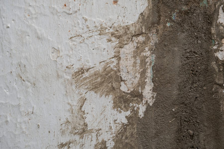 Cement render plaster coating on old white lime washed wall