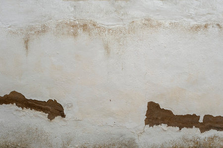 Old weathered white limewashed wall backgroundの写真素材