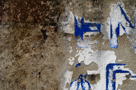 Detail of old wall with scraps of vintage signの写真素材