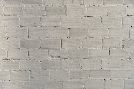 White plaster coating on bricks wall, grunge backgroundの写真素材