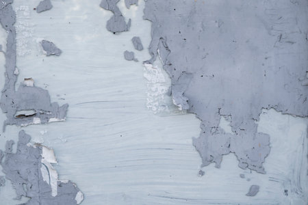 Detail of worn out plaster coating on a closed store window, grunge texture, abstract backgroundの写真素材