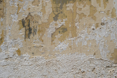 Detail of old painted wall with scraps of flaking paint layers, grunge backgroundの写真素材