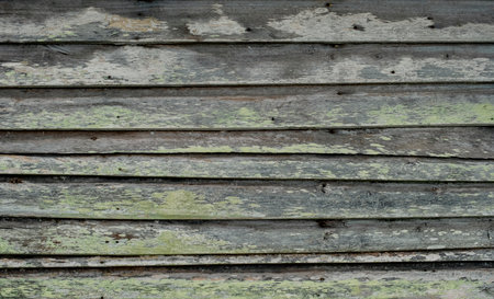 Detail of and old hut wooden wall with worn out paintの写真素材