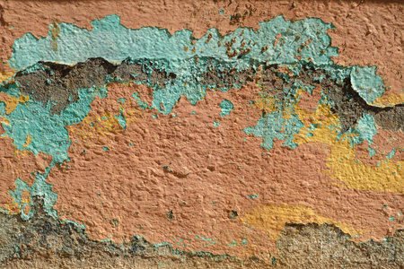 Detail of pastel colored flaking paint layers on old weathered wall, grunge backroundの写真素材