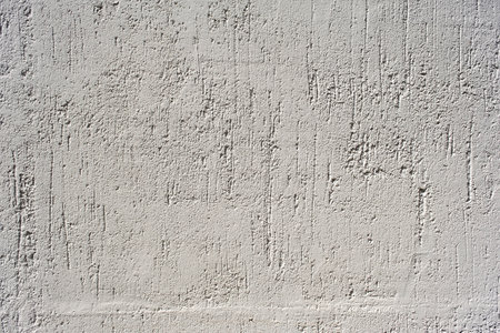 Detail of white scrapped plaster finish wall textureの写真素材