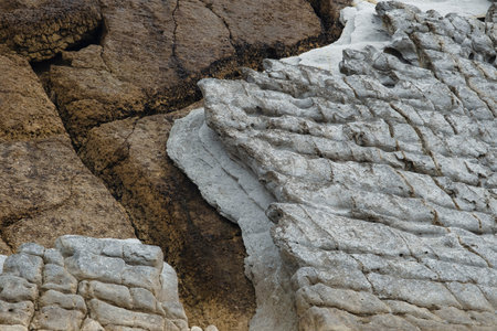 Coastal erosion of sedimentary rocks and landforms displaying the lithological contact of Cenomanian...