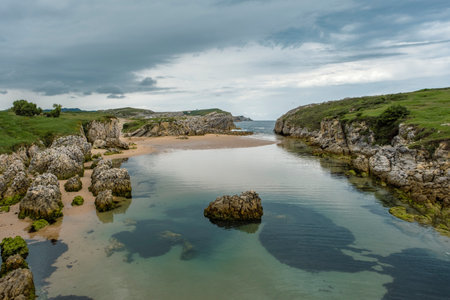 Beautiful rocky seascape in Playa Virgen del Mar, Costa Quebrada, Cantabria, Spainの写真素材