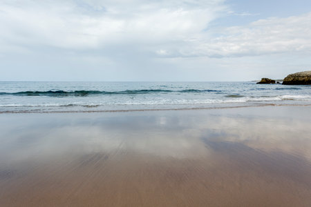 Beautiful and quiet sandy beach Playa Virgen del Mar, Costa Quebrada, Cantabria, Spainの写真素材
