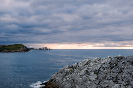 Deep blue sea and rocky coastline, beautiful seascape in Isla de la Virgen del Mar, Costa Quebrada, Cantabria, Northern Spainの写真素材
