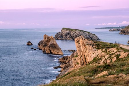 Beautiful coastal landscape at sunset along the Broken Coast of Liencres, Cantabria, Spainの写真素材