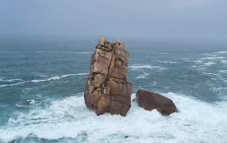 Urro El Buho in rough weather, sea stack carved out by wave action in the Cantabrian Coast. Urros de Liencres, Costa Quebrada, Cantabria, Spain.の写真素材