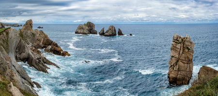 Spectacular coastal landscape with steep cliffs and rocky formations carved out by wave action. Urros de Liencres, Costa Quebrada, Cantabria, Spainの写真素材