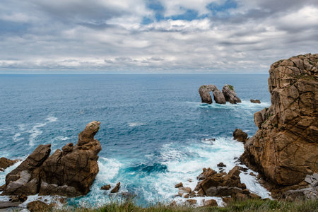 Spectacular coastal landscape with steep cliffs and rock formations carved out by the wave action of the Cantabrian Sea. Urros de Liencres, Costa Quebrada, Cantabria, Spainの写真素材