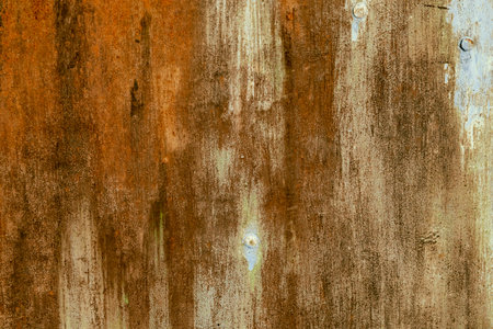 Detail of old rusted metal sheet with worn out paint, grunge backgroundの写真素材