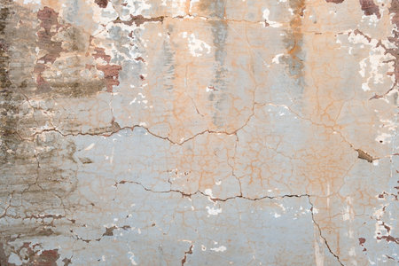 Old cracked wall with worn out blue paint, grunge backgroundの写真素材