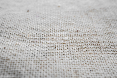 Macro detail of woven white linen natural fabric texture background, selective focusの写真素材