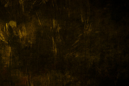 Dark grungy backdrop with gold finishの写真素材