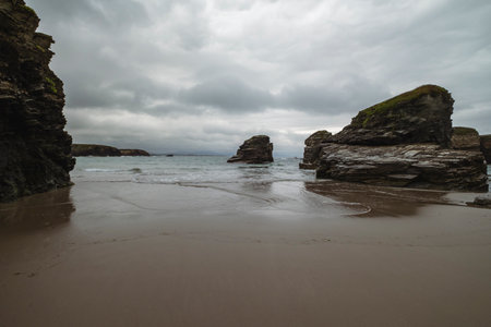 Sand beach and rocky formations in the Cantabrian coast of Ribadeo, Lugo province, Galicia, Spainの写真素材