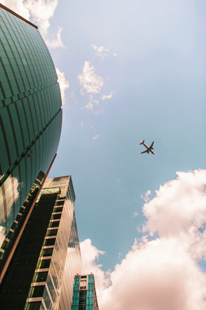 Directly below view of corporate buildings and plane.の写真素材