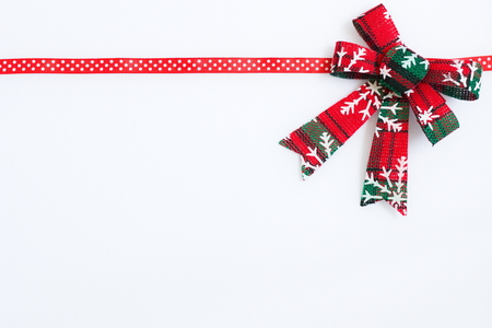 red ribbon with christmas decoration on a white backgroundの写真素材