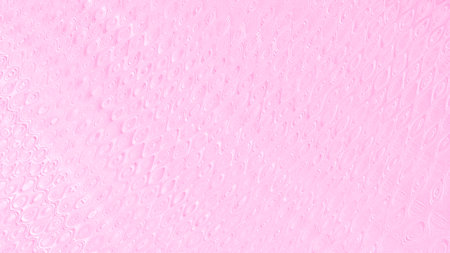 A soft pastel pink background featuring a subtle, textured pattern that adds depth and visual interest. The delicate, light pink hue combined with a gentle, embossed effect.の写真素材