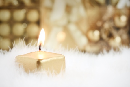 Golden candle, selective focus on flameの写真素材