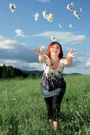 Woman throwing daisiesの写真素材