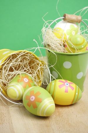 Easter eggs in little buckets on woodの写真素材