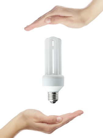 hands and energy saver bulb isolated on whiteの写真素材