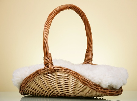 Wicker basket with blanket against yellow backgroundの写真素材