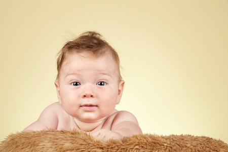Adorable baby boy on fur blanketの写真素材