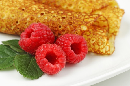 Pancakes with raspberries served on plateの写真素材