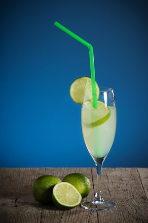Coctail with fresh limes on wooden tableの写真素材